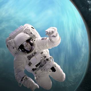 Astronaut near planet wallpaper
