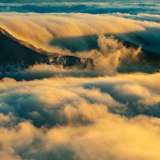 Mountain peaks clouds sunlight wallpaper