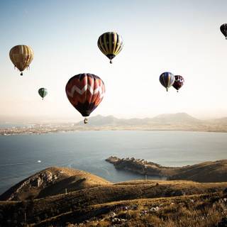 Balloons over sunset wallpaper