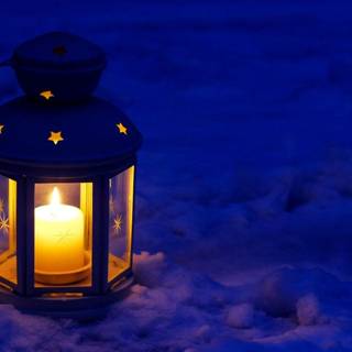 Glowing Christmas candle frosted window wallpaper