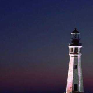 Lighthouse guiding boat wallpaper