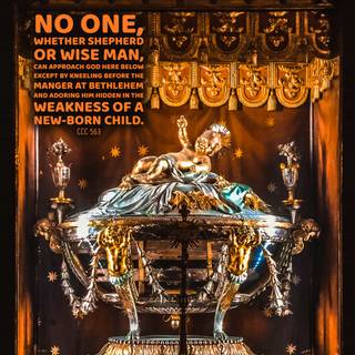 Mary laying baby Jesus in a manger wallpaper