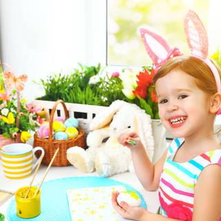 Little girl playing with Easter eggs wallpaper