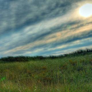 Sun behind clouds wallpaper