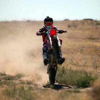 Dirt bike doing wheelies wallpaper
