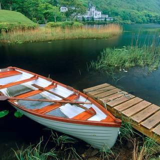 Wooden boat in river wallpaper