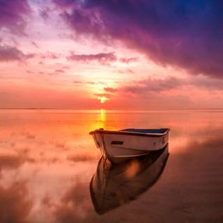Sunset over boat wallpaper