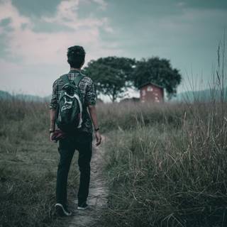 Alone boy walking on road wallpaper