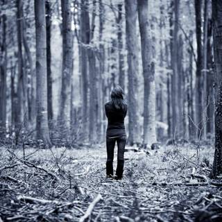 Lonely girl walking alone in the dark wallpaper