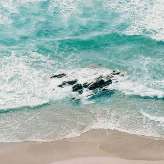 Aerial view beach sand and ocean waves wallpaper
