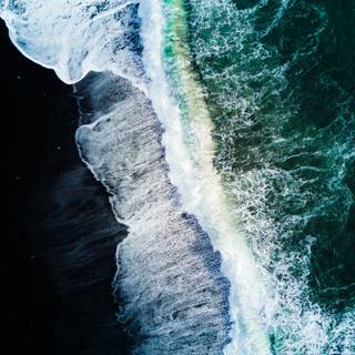 Aerial view beach sand and ocean waves wallpaper