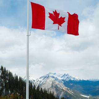 Canada flag in the mountains 4k wallpaper