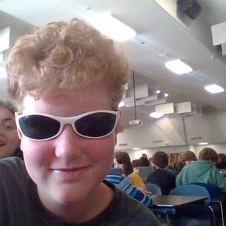 My friend took my sunglasses while my other friend is in the background