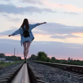 Girl Walking On Train Tracks