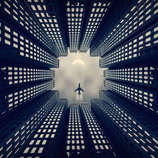 Airplane Flying Over Buildings