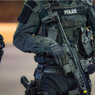  ARMED POLICE HANDS MATE