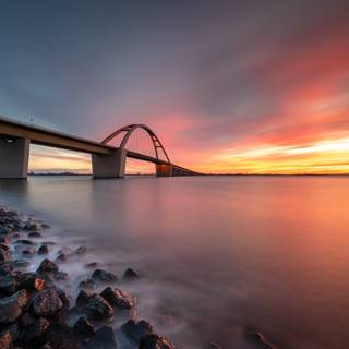 Bridge spans water sunset