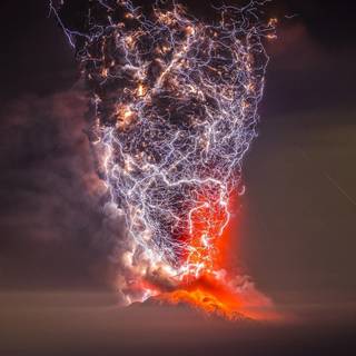 Lightning bursting over erupting volcano