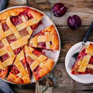 Plăcintă cu prune de casă pe fond rustic