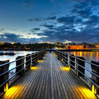 brown wooden dock on body of water during night time