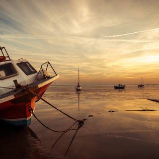 Boat In Low Tide Sunset