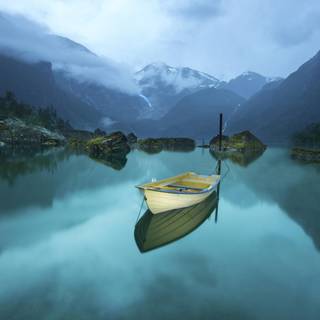 Misty mountain reflections boat