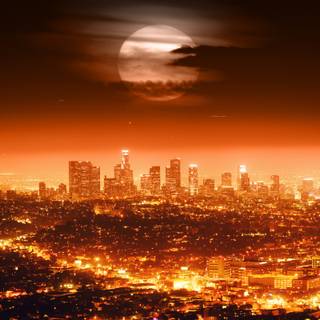 Dramatic Full Moon over Los Angeles Skyline at Night