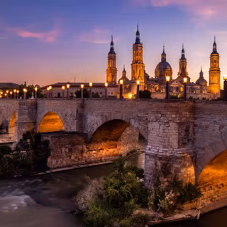 Historic Stone Bridge Over The River At Dusk