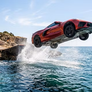 Corvette flying over sea