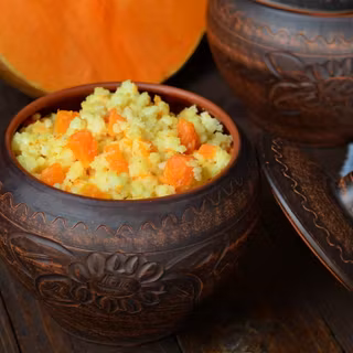 Millet porridge with pumpkin in clay pot 