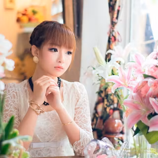 Yurisa Chan in a pink dress with a flower 