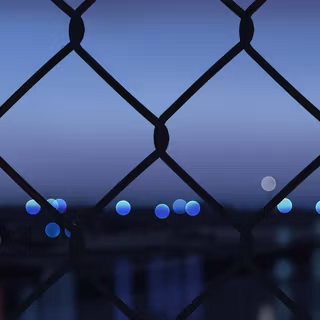 Chain Link Fence with City Bokeh