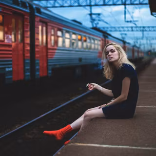 Girl Sitting On Platform Smoking
