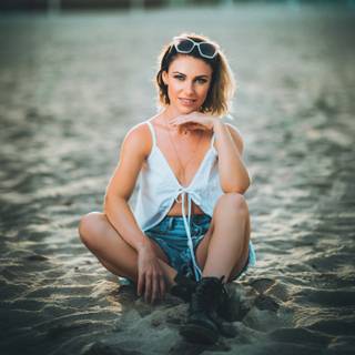Girl Wearing Sunglasses And Boots On The Beach