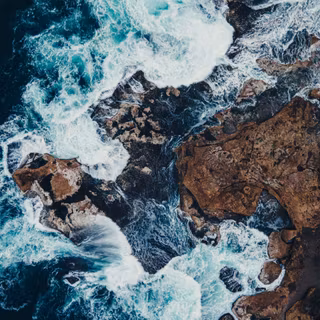 Aerial View Ocean Waves Crashing Rocks