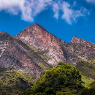 Mountain Range In Occitanie France Under A Vibrant Blue Sky