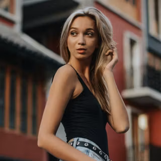 Blonde Hair Girl Wearing Black Tank Top Looking Away
