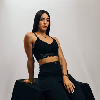 Model Wearing Black Tank Top Looking At Viewer