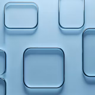 A minimalist 3D render featuring smooth, rounded square glass tiles in a light blue hue, layered to create depth and subtle, clean reflections.