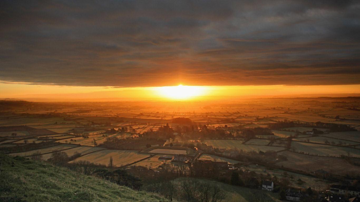 Bing Image Archive: The sun rises over the Somerset Levels viewed