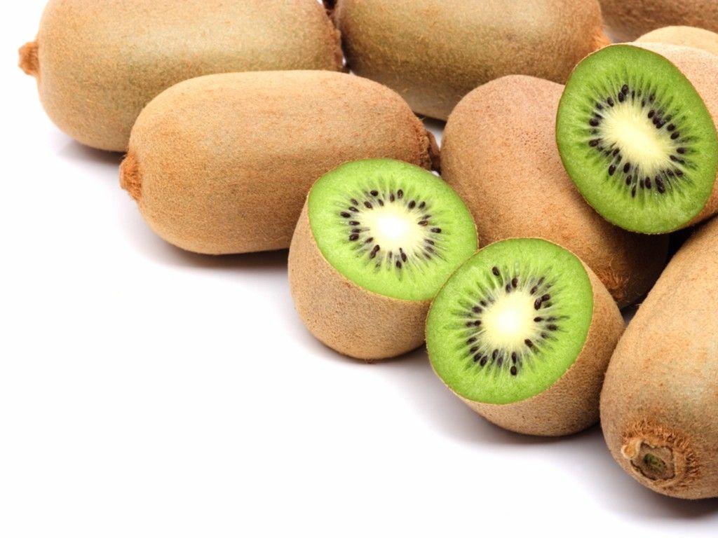 Pile of fresh kiwi fruit isolated on white background
