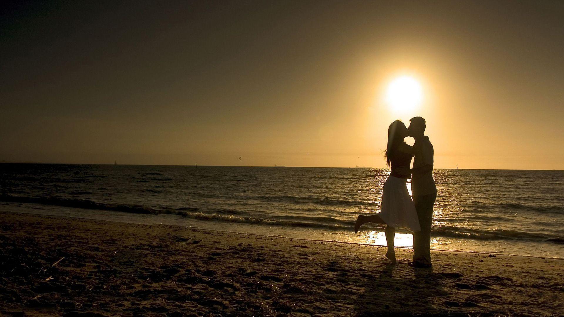 Couple Kiss On Beach at Sunset