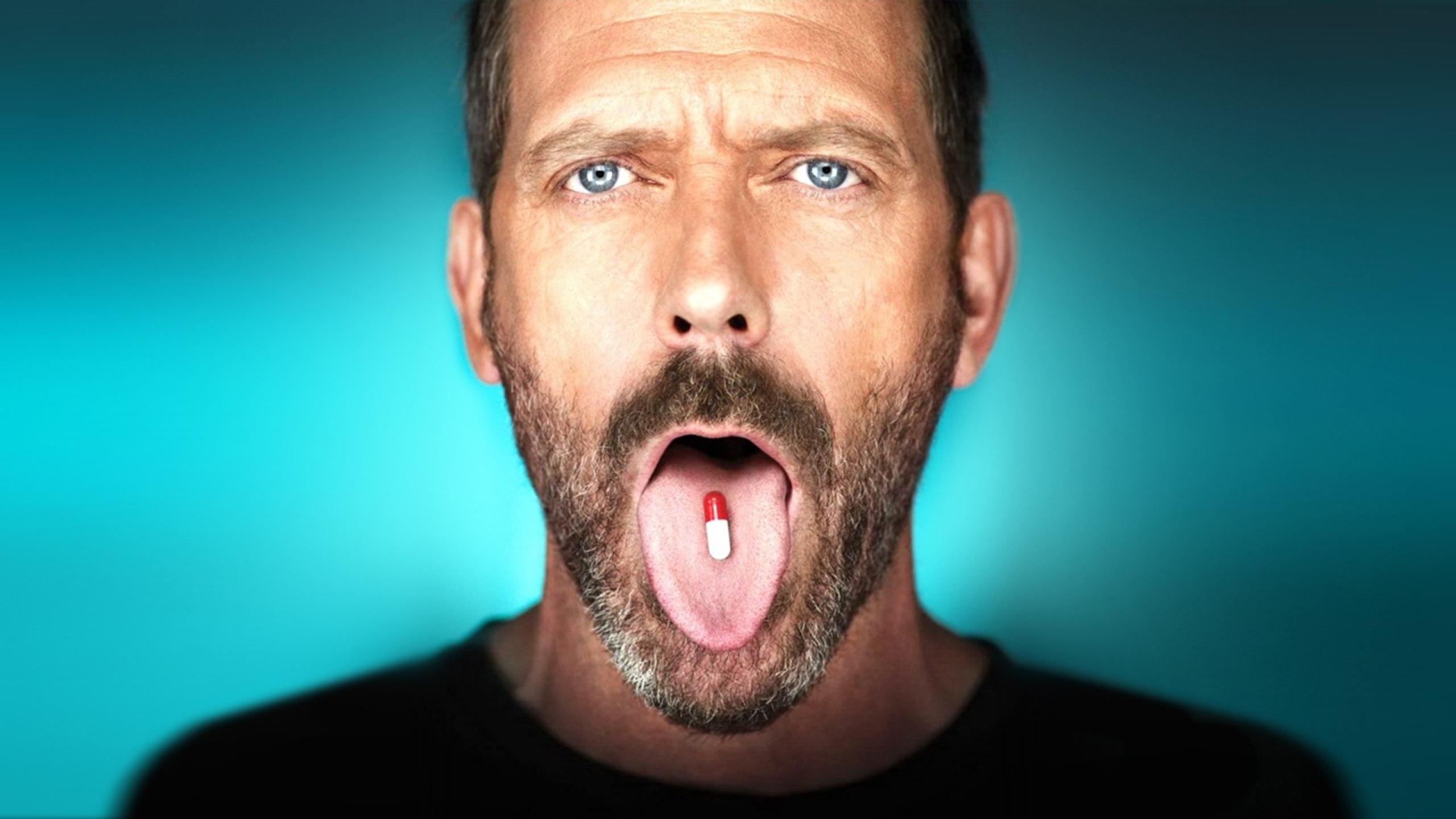 Download Free 2560x1440 Hugh Laurie Taking Pill Desktop Wallpaper