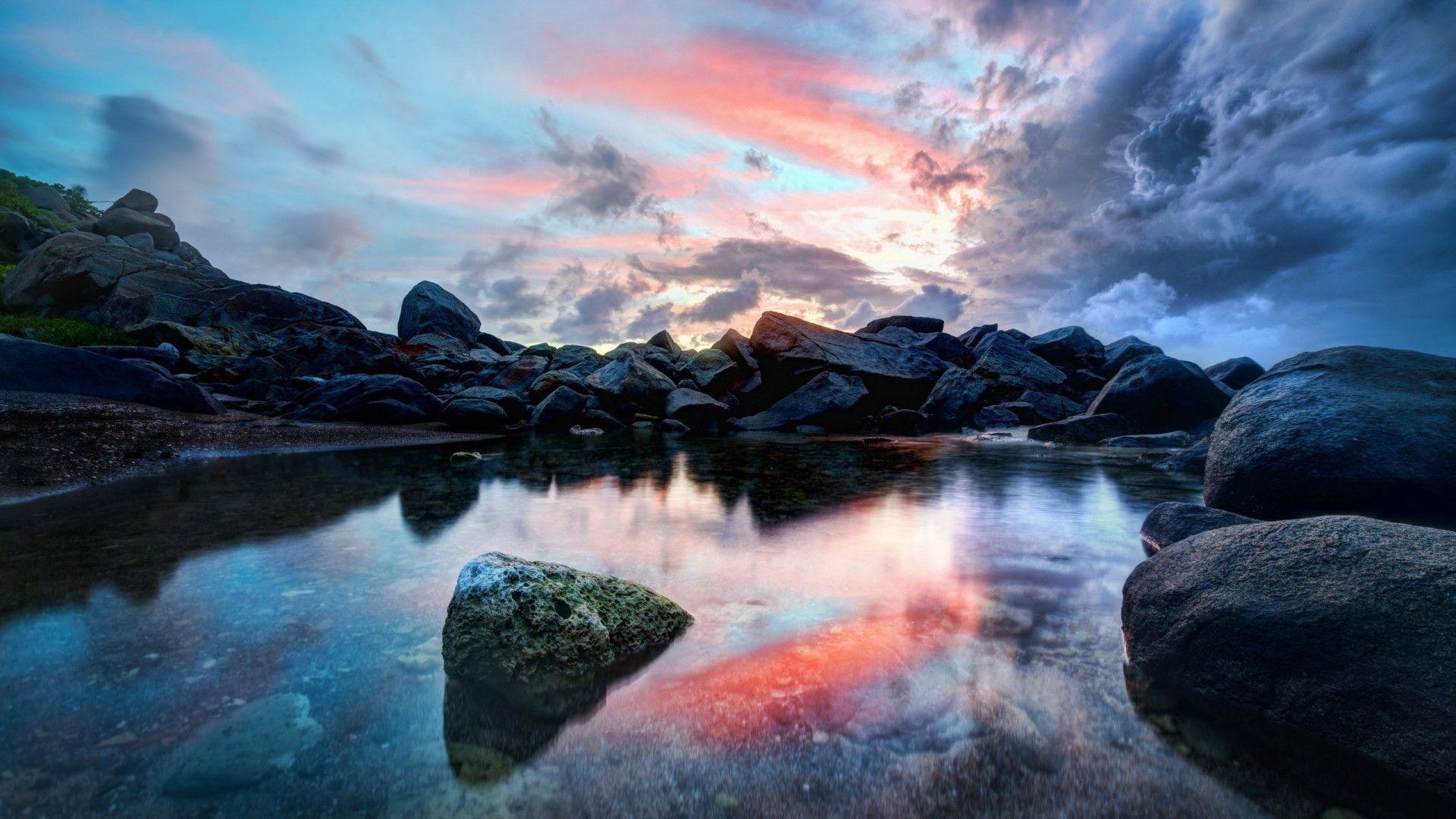 HD Wondrous Reflection In Rocky Pond Wallpaper