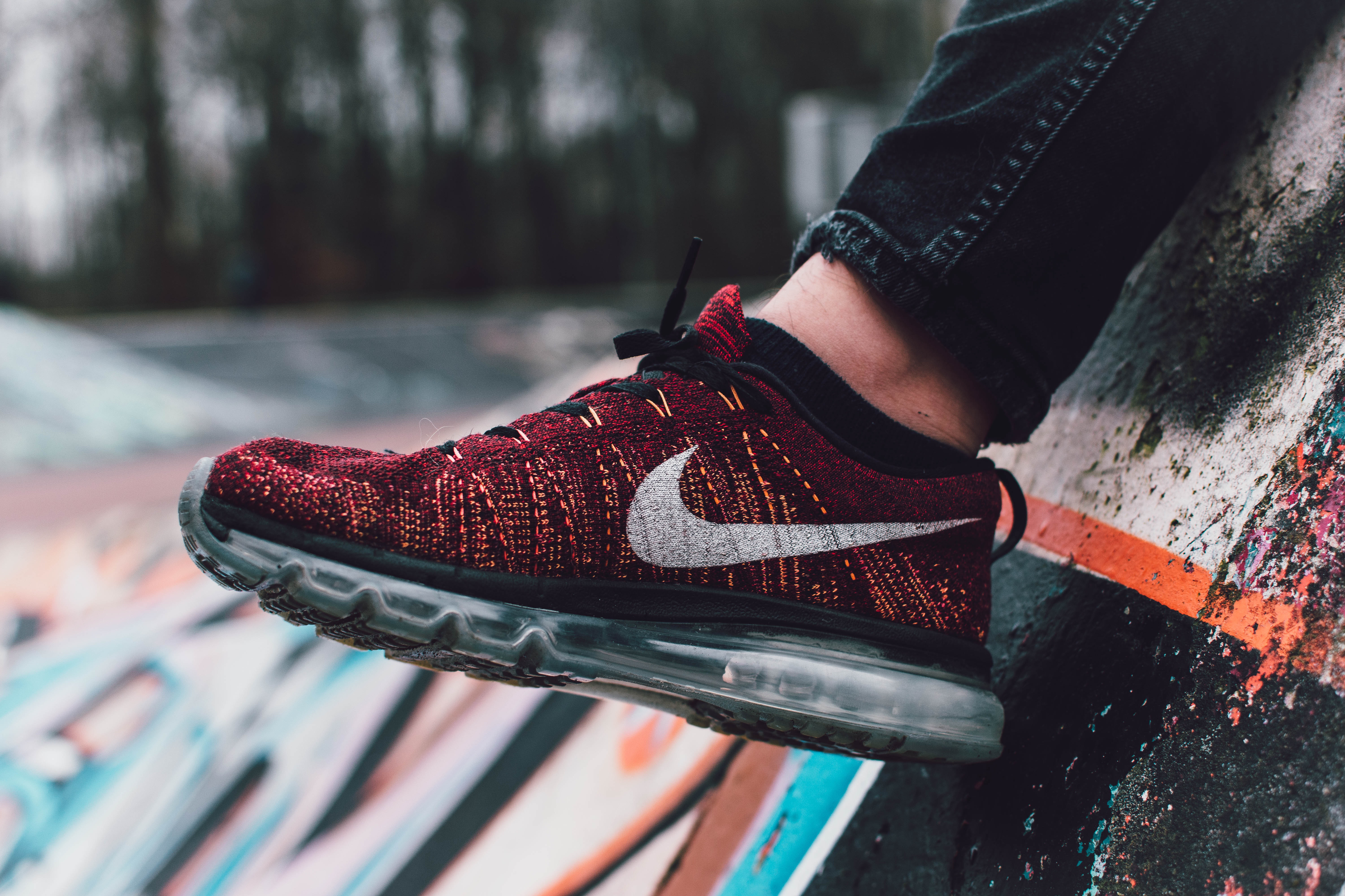 Close Up Photography Of Red And Black Nike Running Shoe · Free