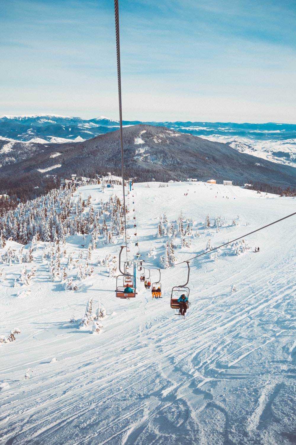 people riding in cable cart on winter season photo