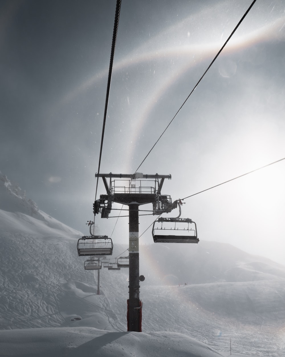 black cable car over snow covered ground photo