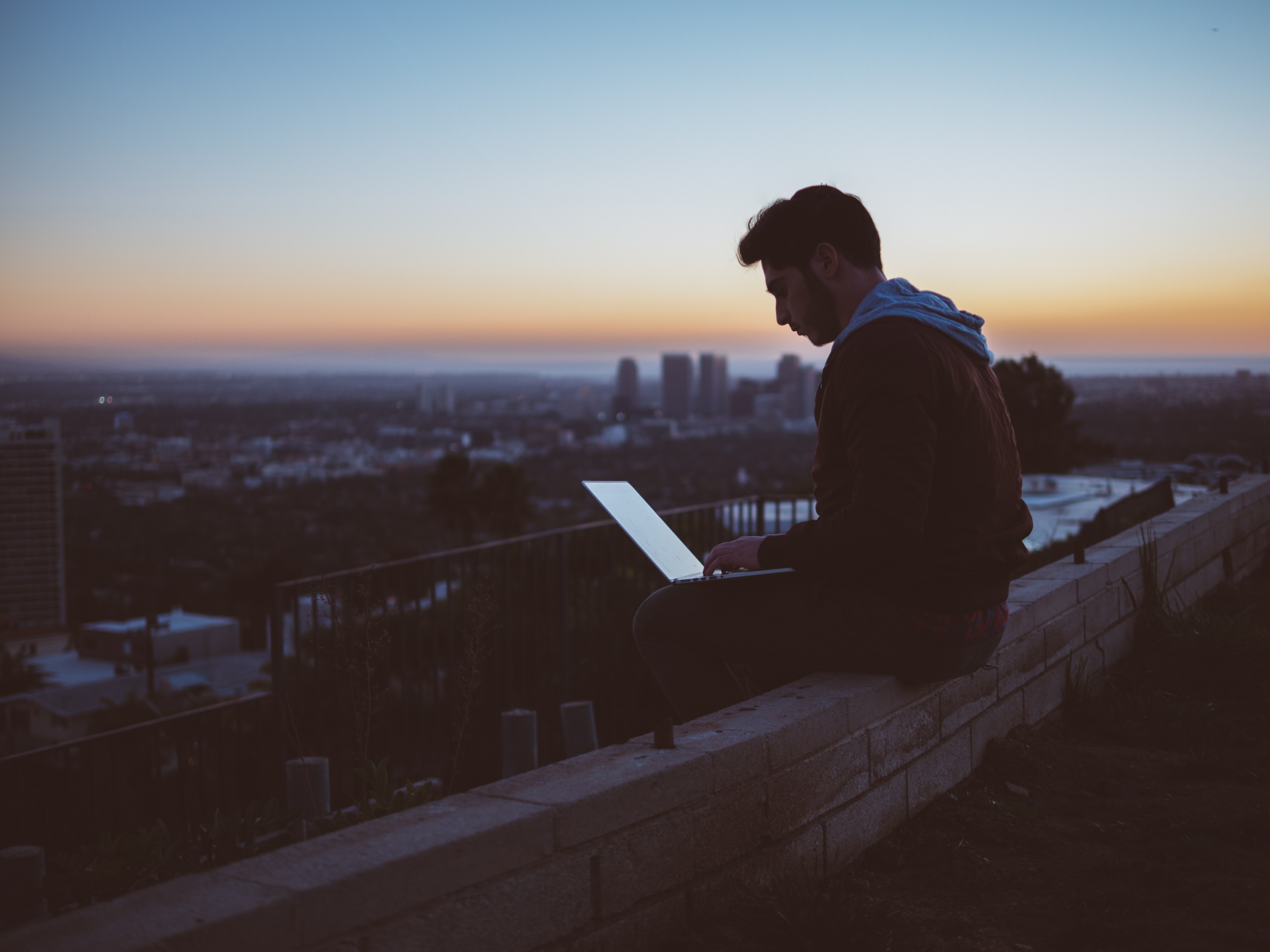 4608x3456 #sit, #person, #guy, #male, #sunset, #hoodie, #man, #Public domain image, #working, #sat, #computer, #sitting, #laptop, #skyline, #work, #cityscape, #roof, #workspace, #city, #rooftop, #urban. Mocah HD Wallpaper