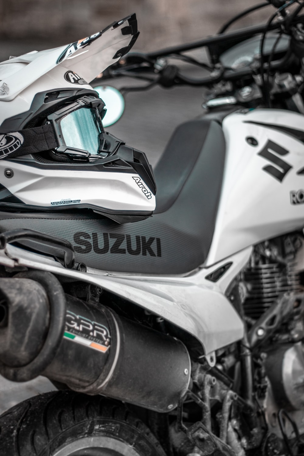 white Suzuki dirt bike with helmet photo