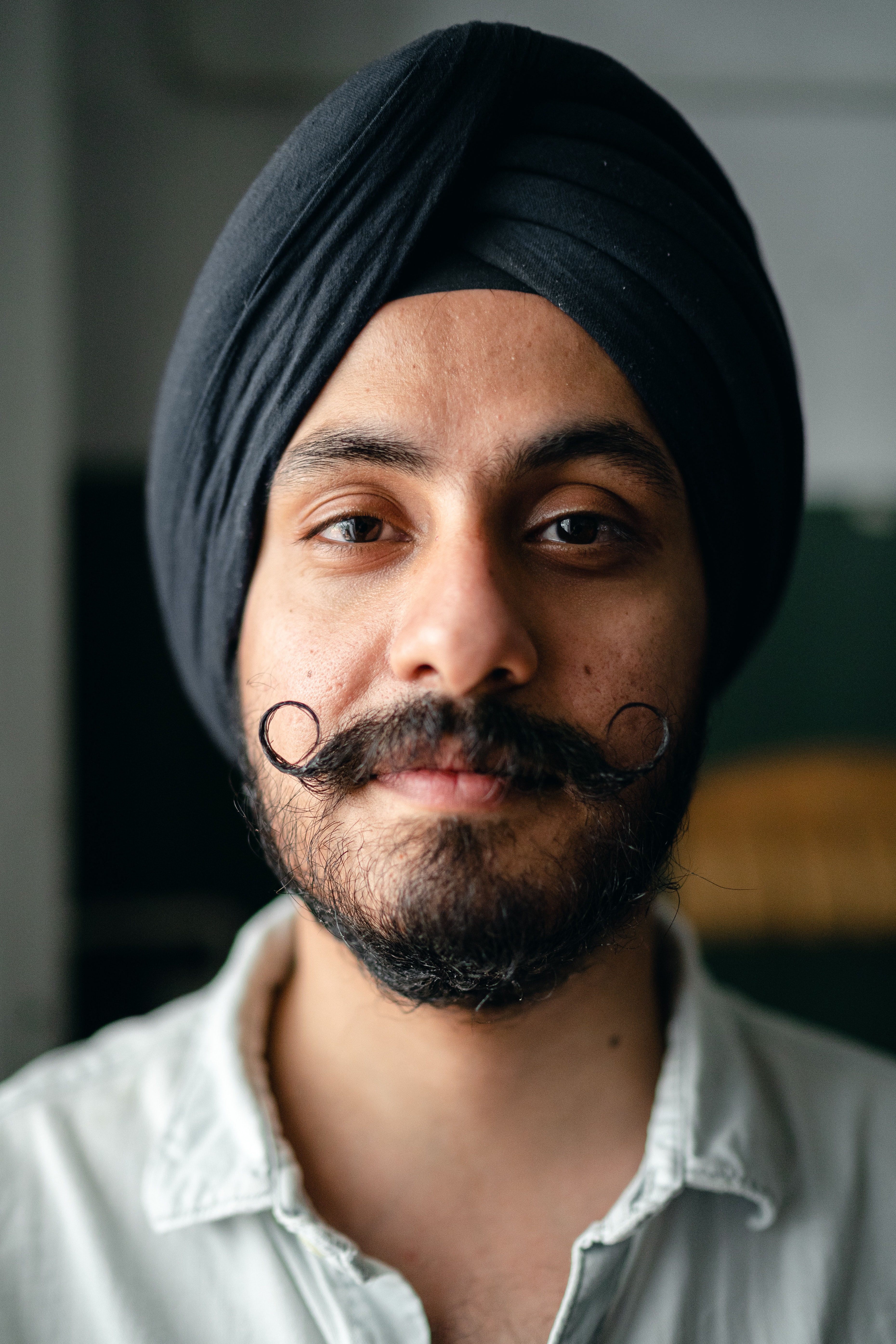 Positive bearded young Indian guy in turban · Free